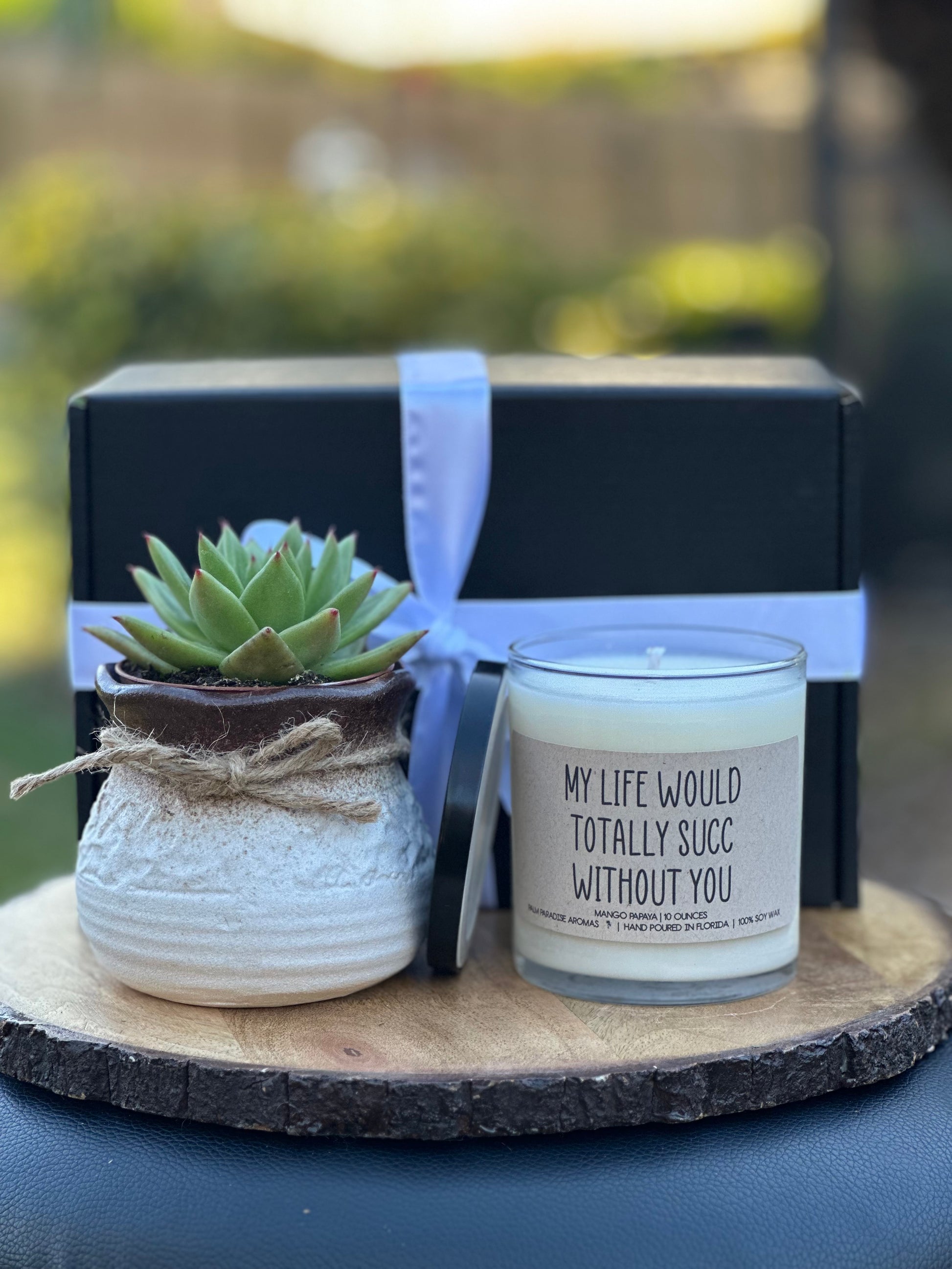 a candle and a potted plant on a table