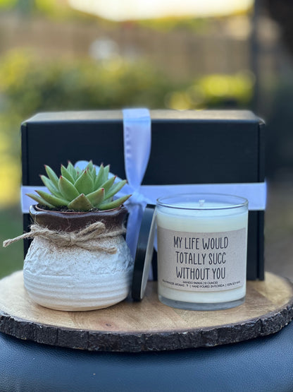 a candle and a potted plant on a table